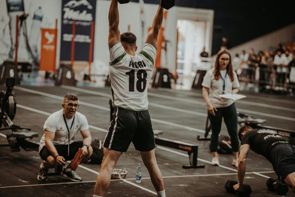 Athletes competing fiercely in an indoor gym, showcasing strength and determination.