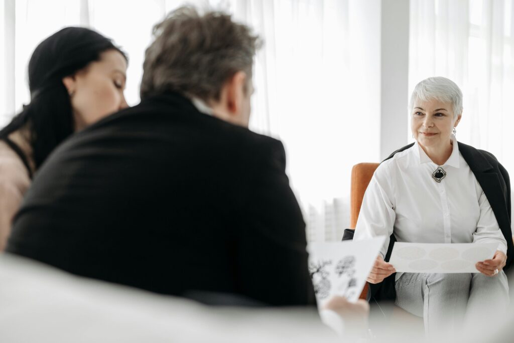 A diverse group engaged in a professional consultation in a modern, well-lit office setting.